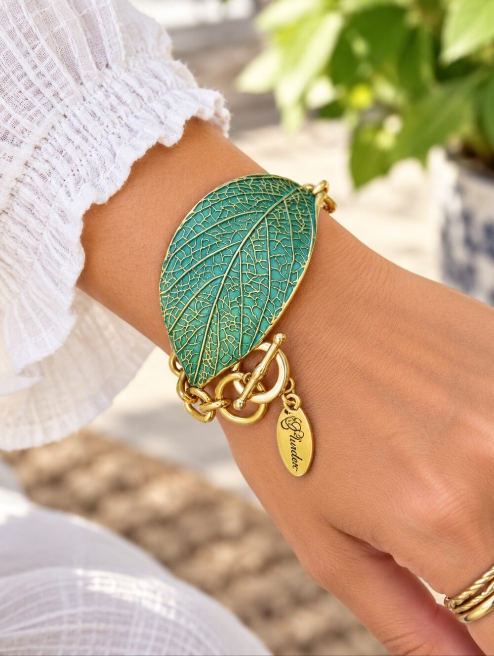 Plunder gold tone green leaf bracelet